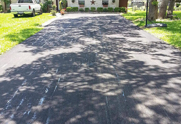 Freshly repaired driveway paved by Austin Affordable Asphalt