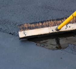 Man,sealing,asphalt,driveway